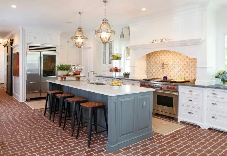 Gray kitchen island design with brown brick floor