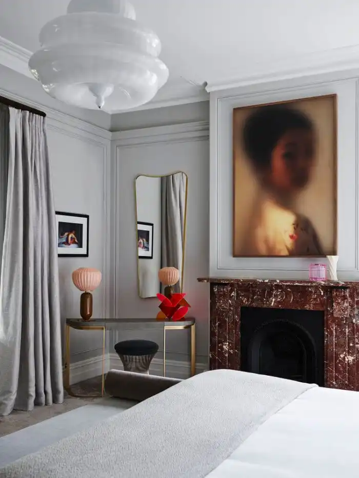 Gray room with painting and a brown fireplace