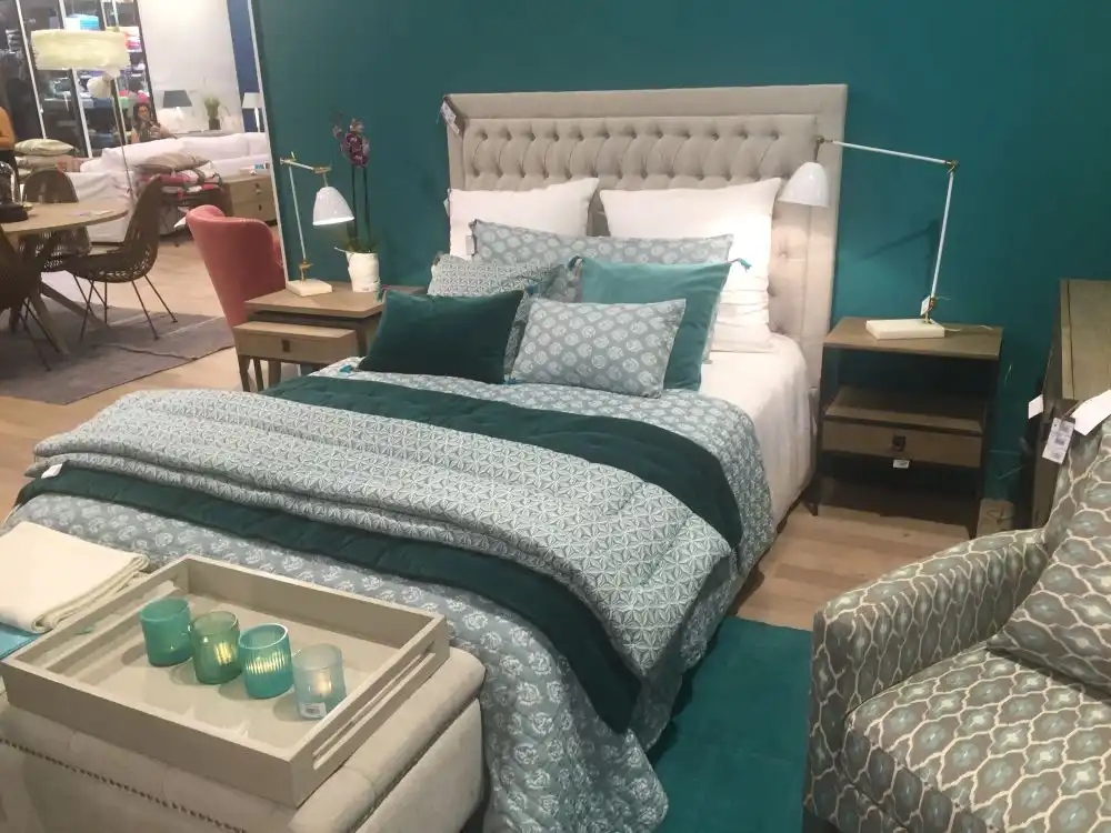 Gray tufted headboard and blue accens for bedding