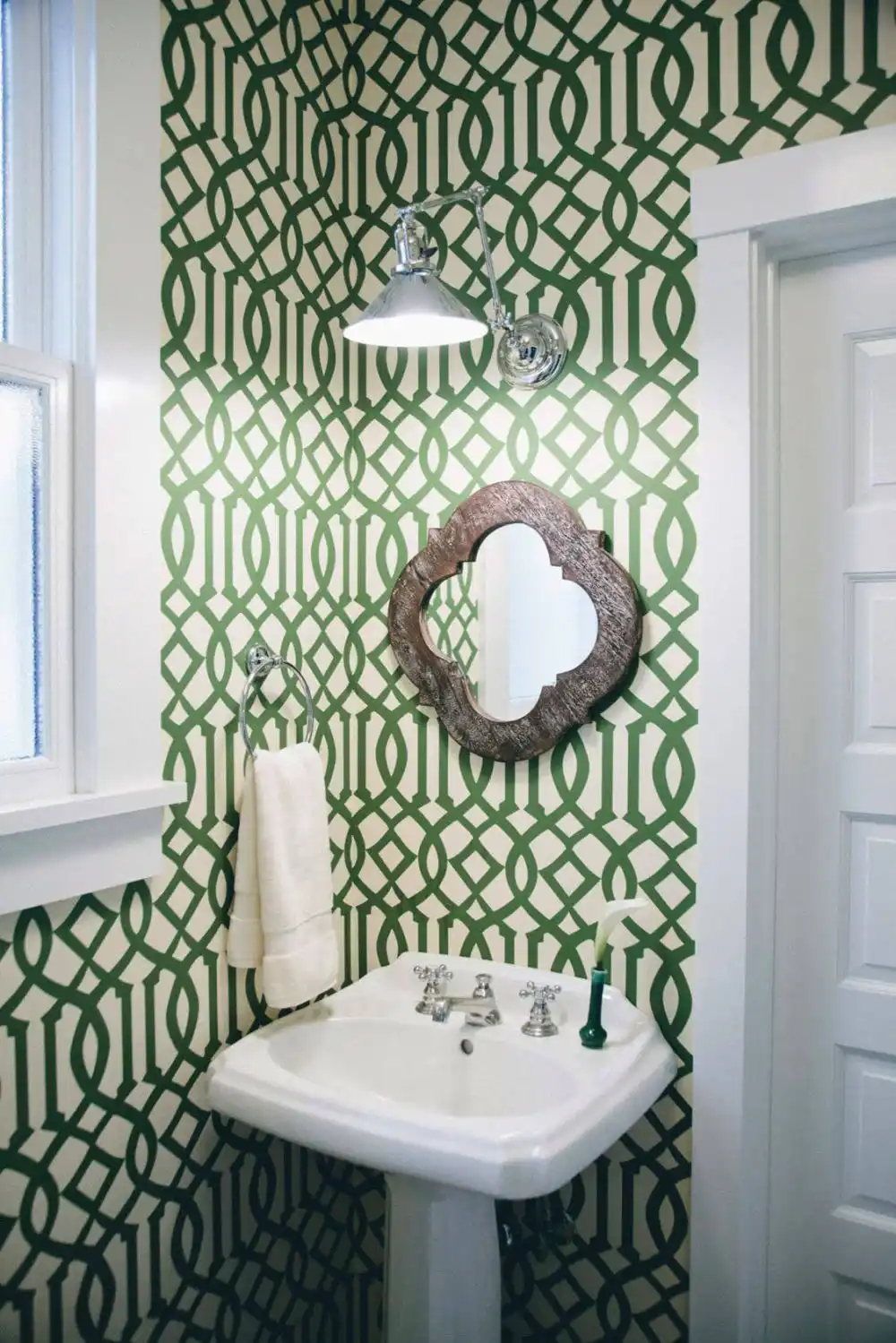 Green bathroom wallpaper with a geometric pattern