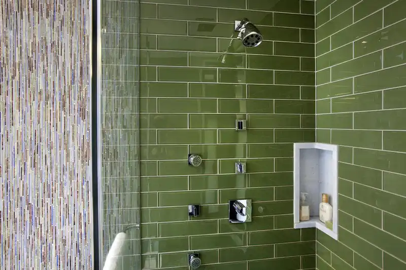 Green shower tiles with small niche