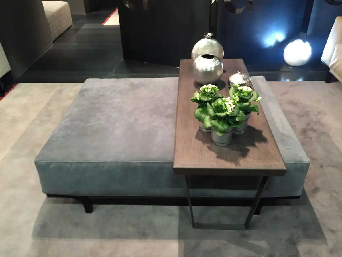 Grey ottoman chair with a table above