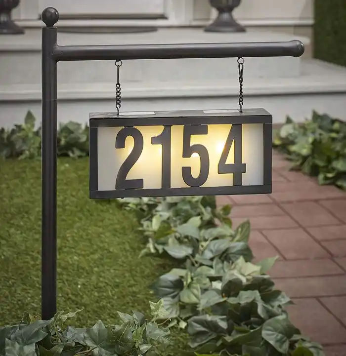 Hanging house number plaque with warm lighting