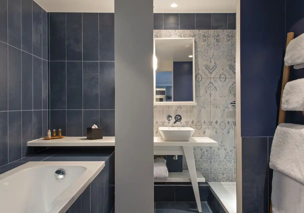 A deep, narrow tub and ladder towel rack are convenient features.