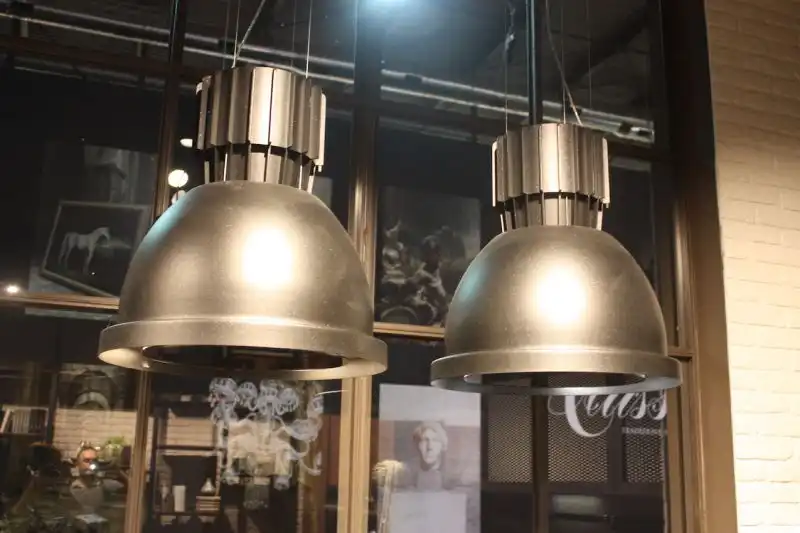 This industrial style spotlight design was popular for kitchen island lighting in many brand exhibits. The gray metallic tone of this one shown by Cucine Lube makes it a versatile, neutral fixture.