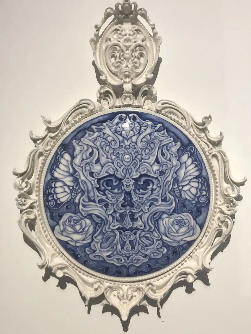 The mix of rococo elements and the trippy central design come together in a marvelous porcelain work.