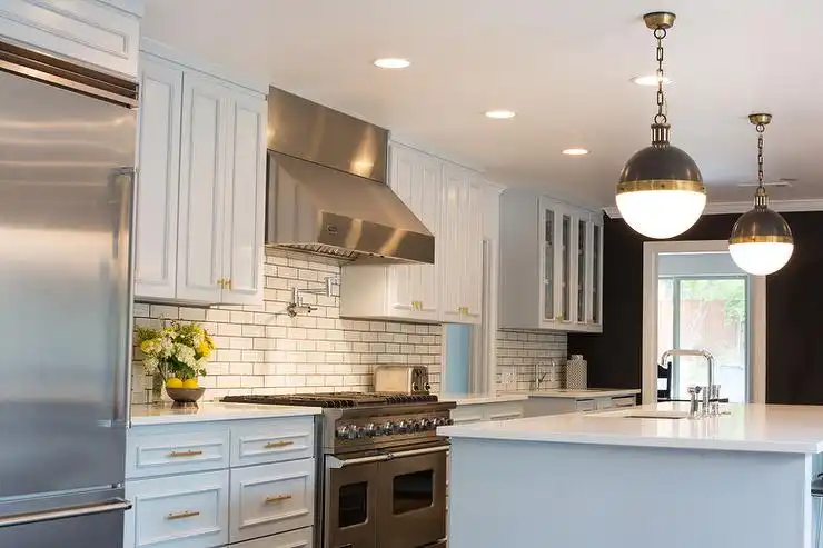 Kitchen with stainless stell accents and subway tiles