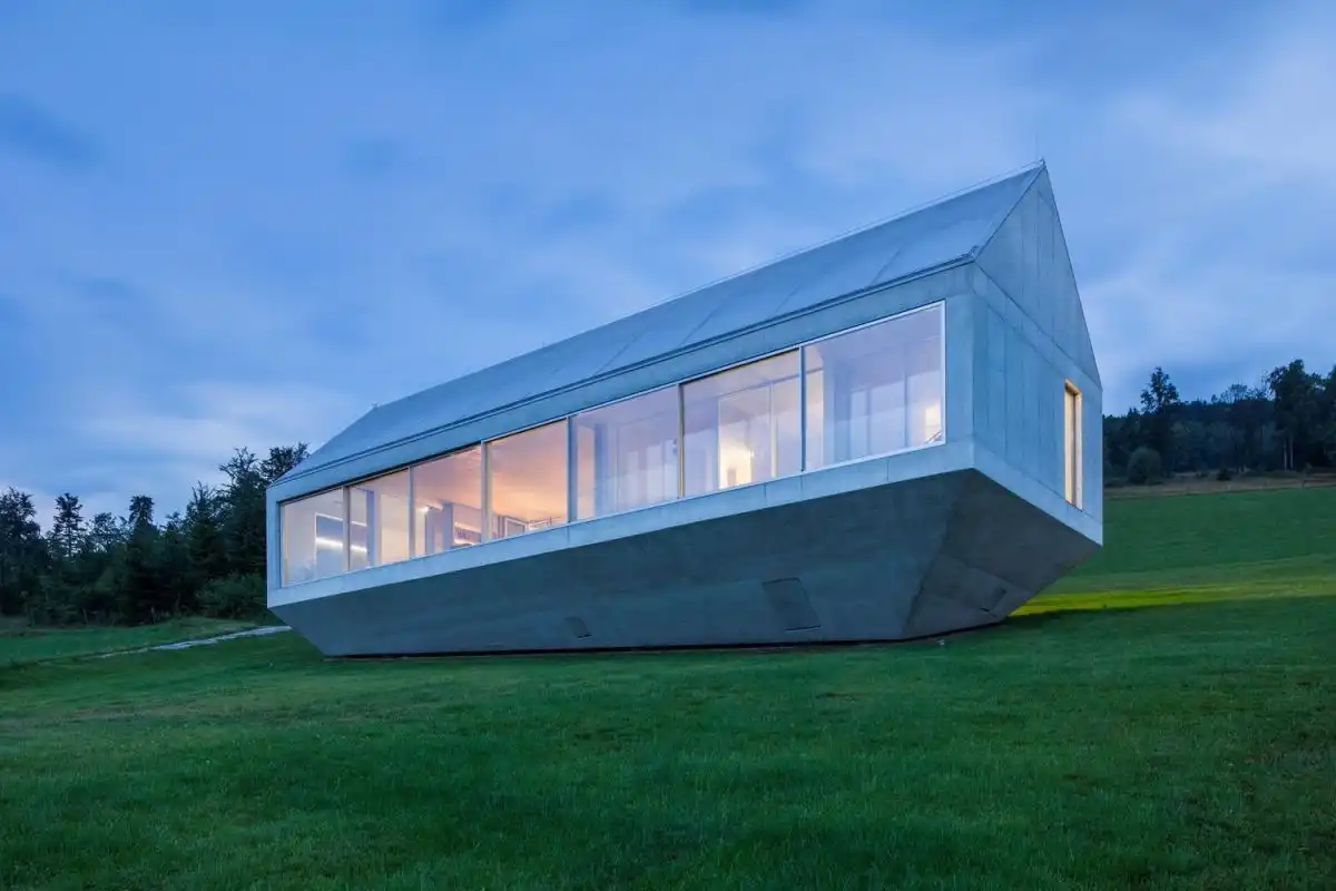concrete house in a forest clearing