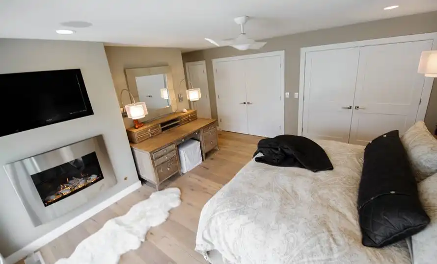 Large bedroom with fireplace and dressing table
