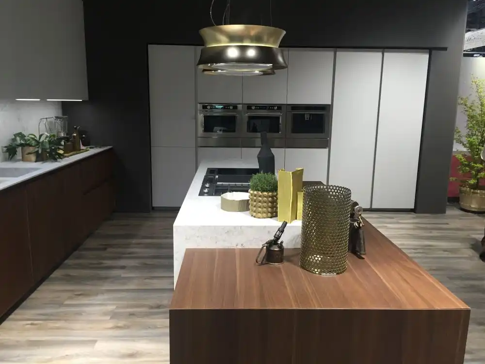 Large kitchen design with brown cabines and white - countertop from marble
