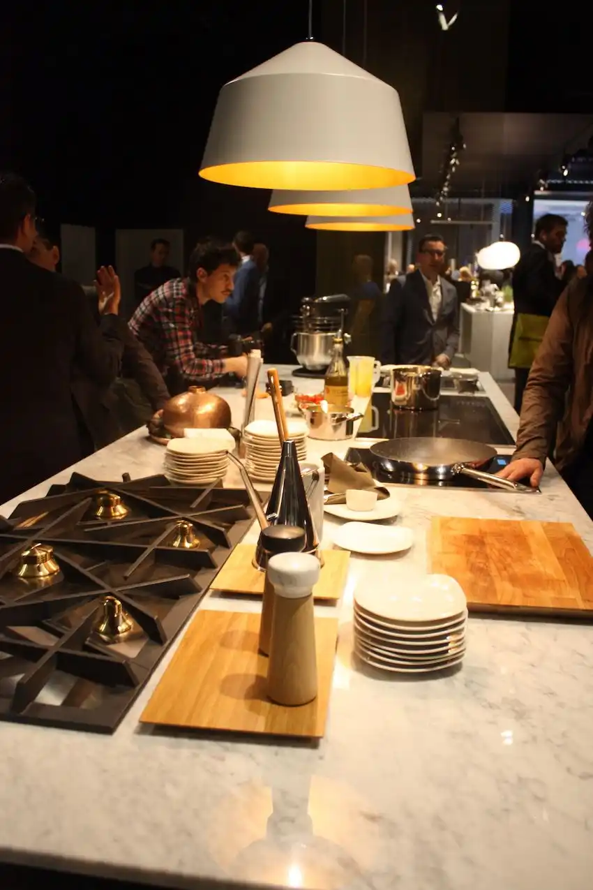 Large modern domes with a metallic interior served as pendant lighting for the Electrolux demonstration kitchen display. A single pendant would also be nice over a dining area.