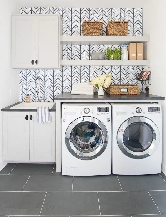 Laundry room with wallpaper and floating shelves