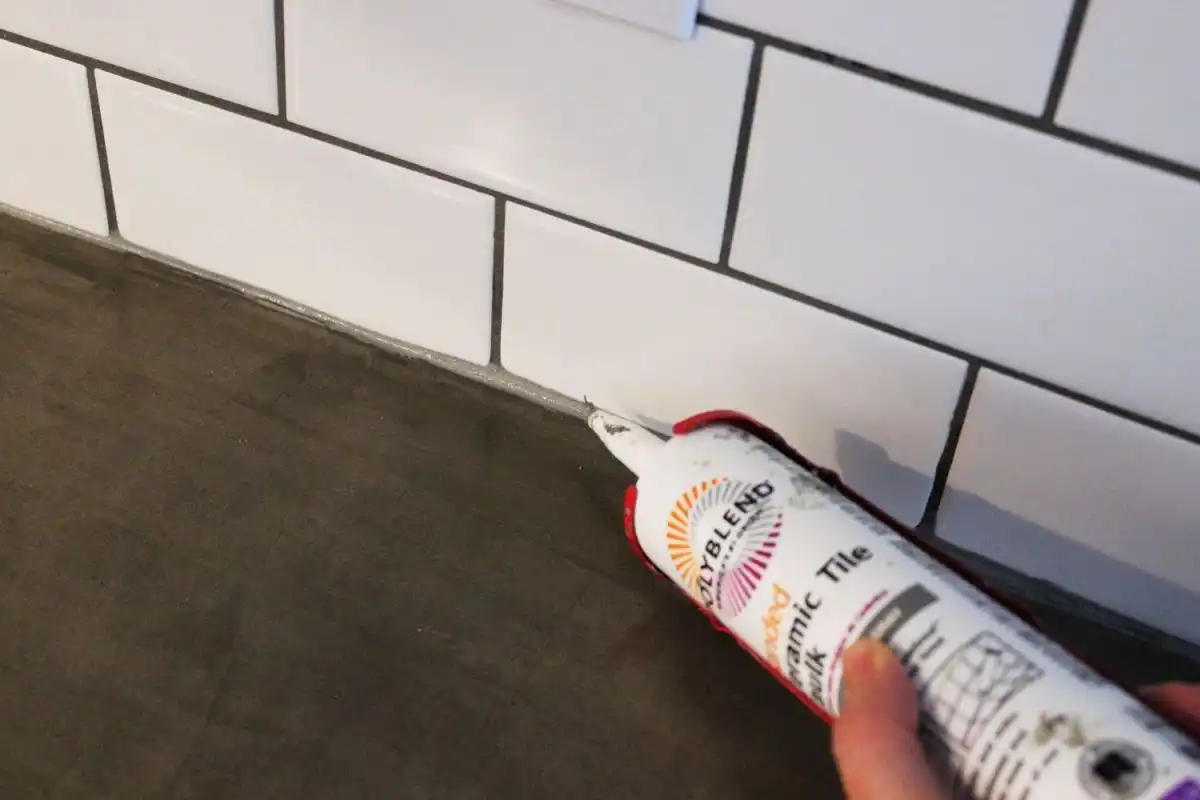 Lay a thin strip of caulk along