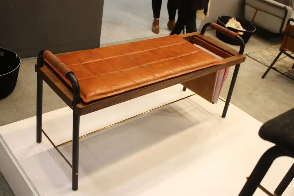 Leather bench with brass base and magazine holder