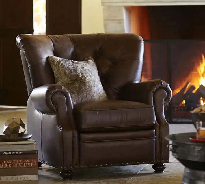 This leather easy chair has a classic, conservative shape and upholstery style.