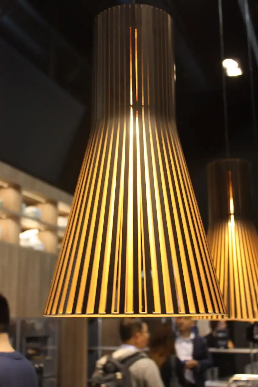 The slatted pendant lighting fixture adds another element of texture to an otherwise smooth and contemporary kitchen design.