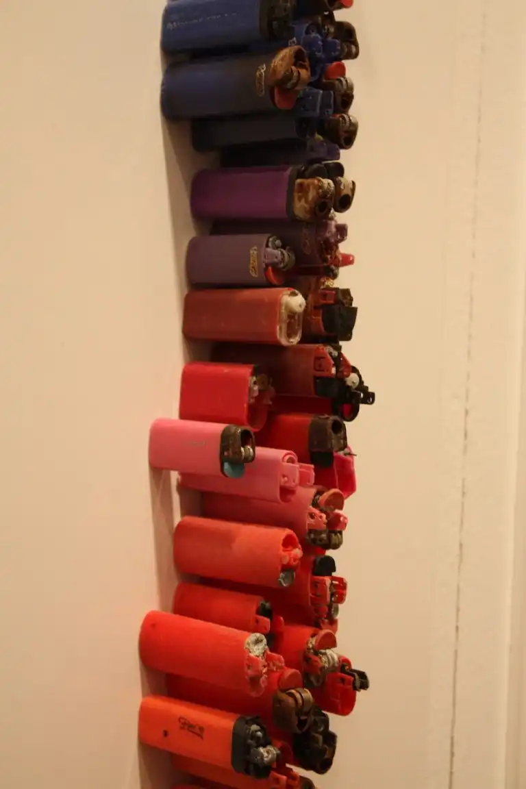 Lighters of many sizes were salvaged for the piece.