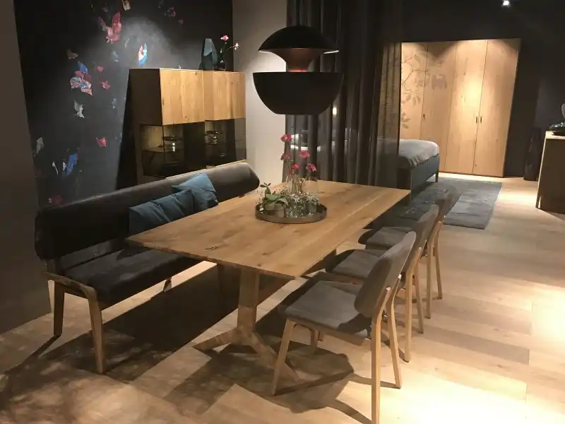 Lighting fixtures above dining table and bench with chairs
