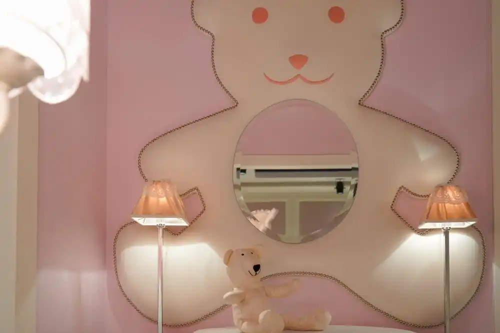 Everything can be customized to look cute in a nursery room, like this mirror framed by a giant teddy bear