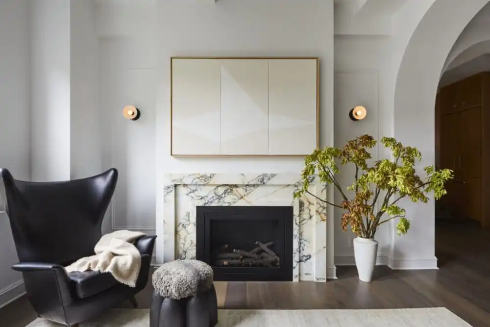 Living Room with black armchair and marble fireplace