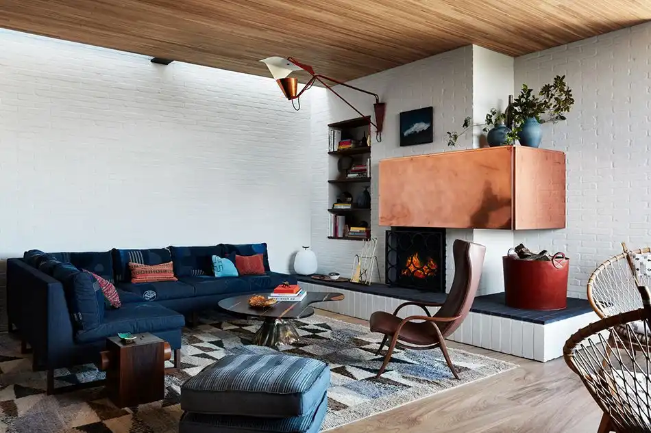 Living Room with brick walls and brass fireplace mantel