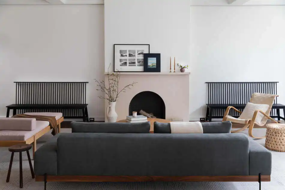 Living Room with fireplace and two benches placed next to it