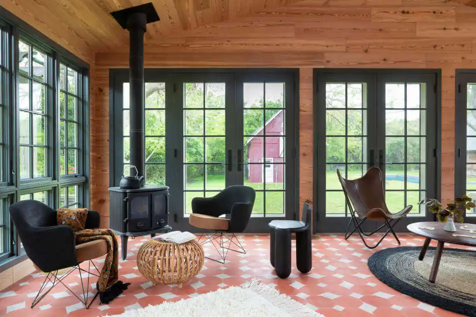 Living Room with red and white floor and fireplace by Elizabeth Roberts Architects
