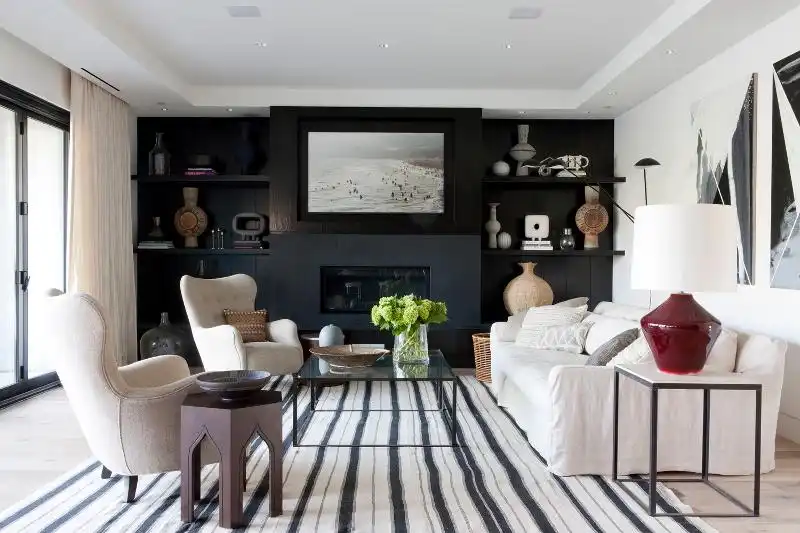 Living room with a black wall and striped carpet