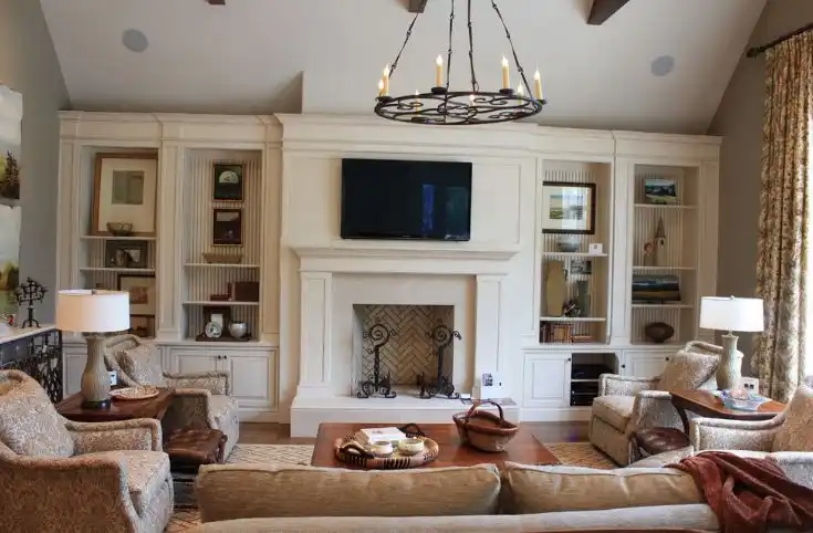 Living room with chandelier and tv on wall