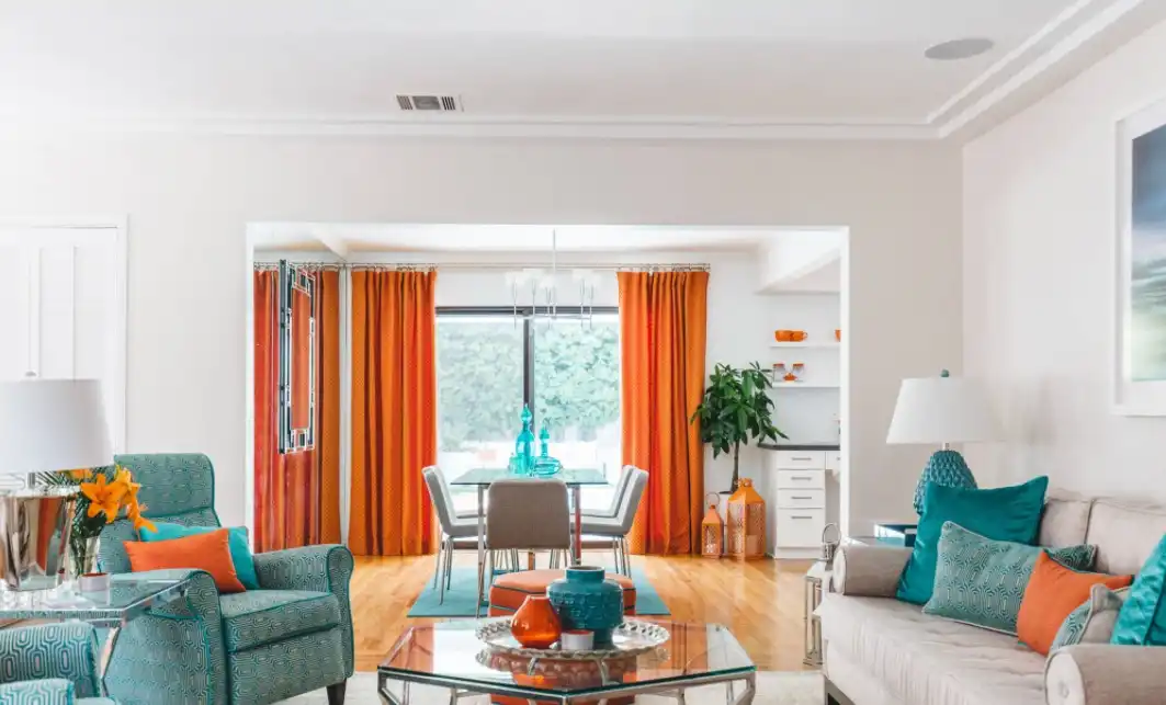 Living room with modern decor and turquoise orange accents