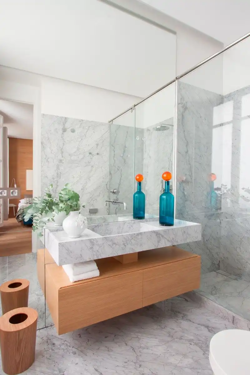 Marble bathroom with wooden shelf cupboard