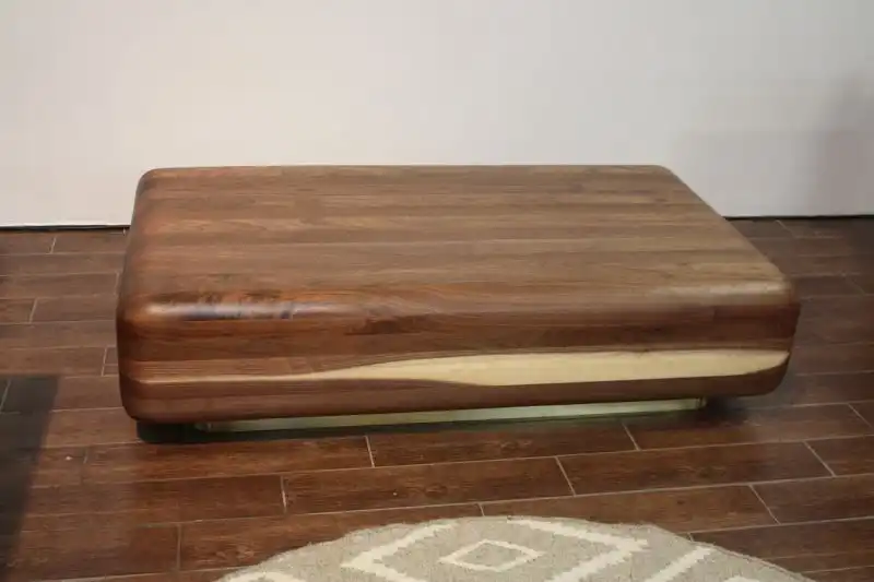 Stunning wood is the outstanding feature of this pieces, further enhanced by the smooth and lustrous design. Mark Jupiter is a fourth generation NYC furniture Builder. Inspired his great grandfather, who hammered out the original copper roofs of the city’s first skyscrapers, and his father, who hand-carved furniture designed Jupiter is carrying the family tradition of building one-of-a kind pieces designed to last. This coffee table is comprised of hundreds of separate pieces of wood, hand carved to form this conversation piece.