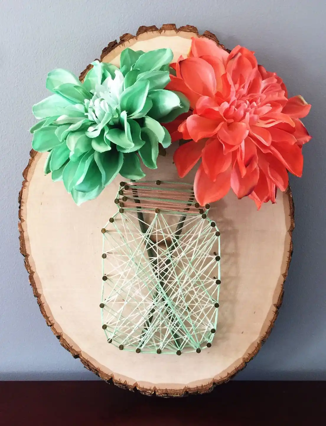 Mason jar string art on log