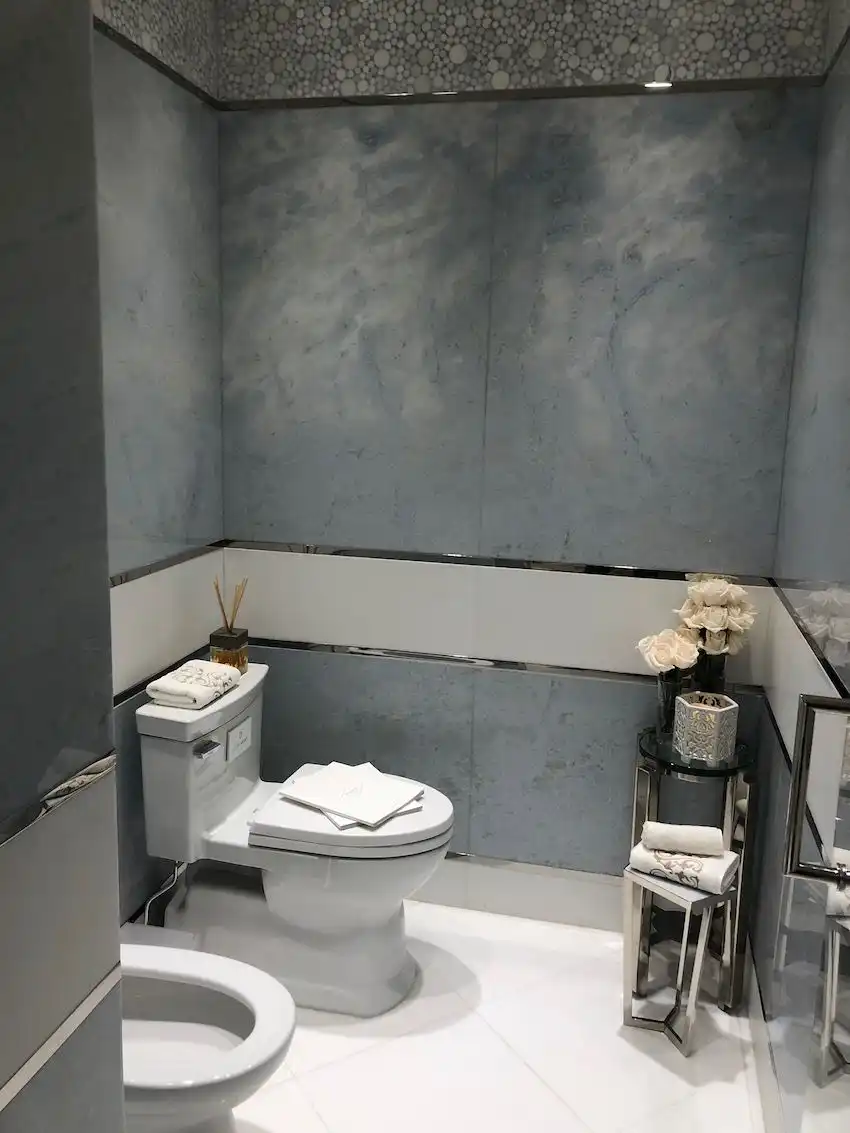 The bedroom's blueish-gray accents are repeated in the bath with a more contemporary flair.