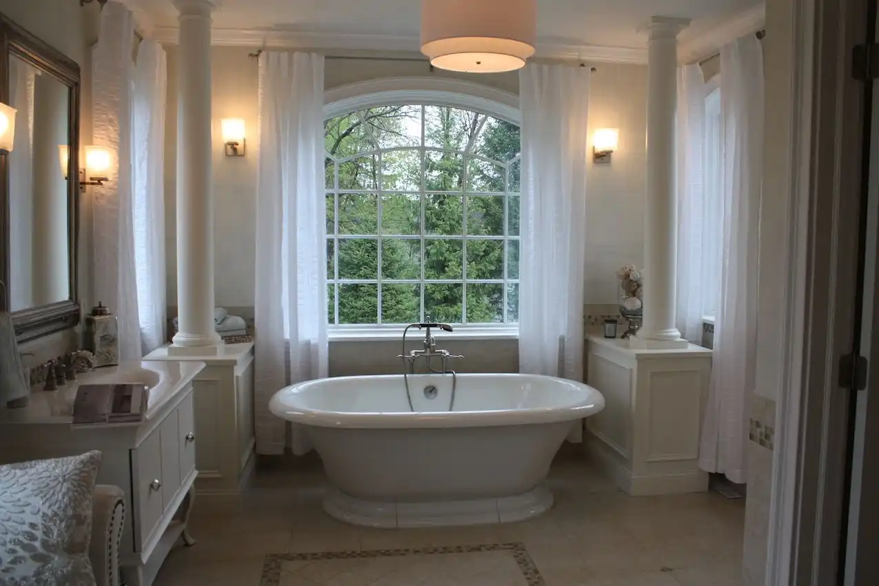 Master bathroom with freestanding tub placed against the window
