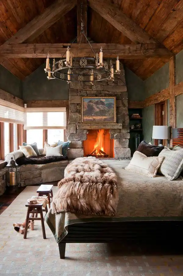 Master rustic bedroom design with chandelier and fireplace