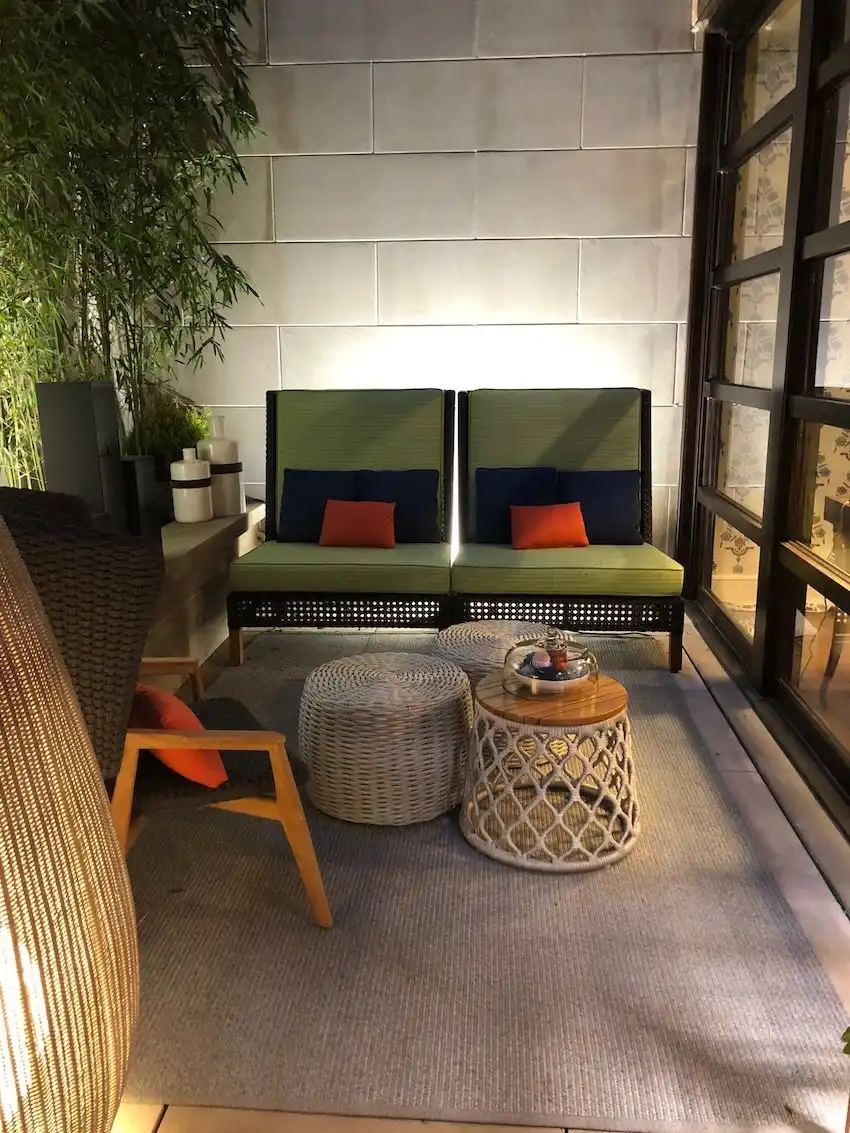 The two chairs have an architectural feel and blend well with the greenery.
