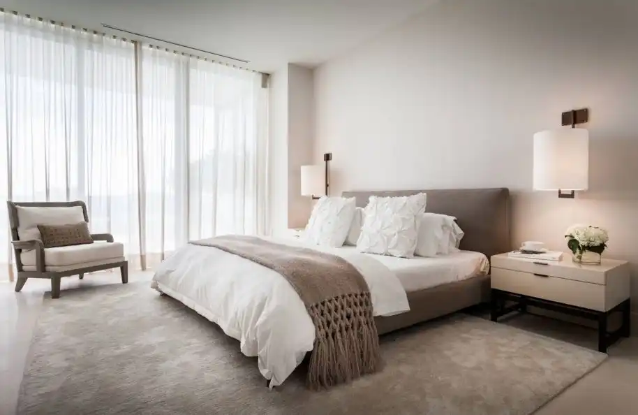 Minimalist taupe bedroom design with a low bed
