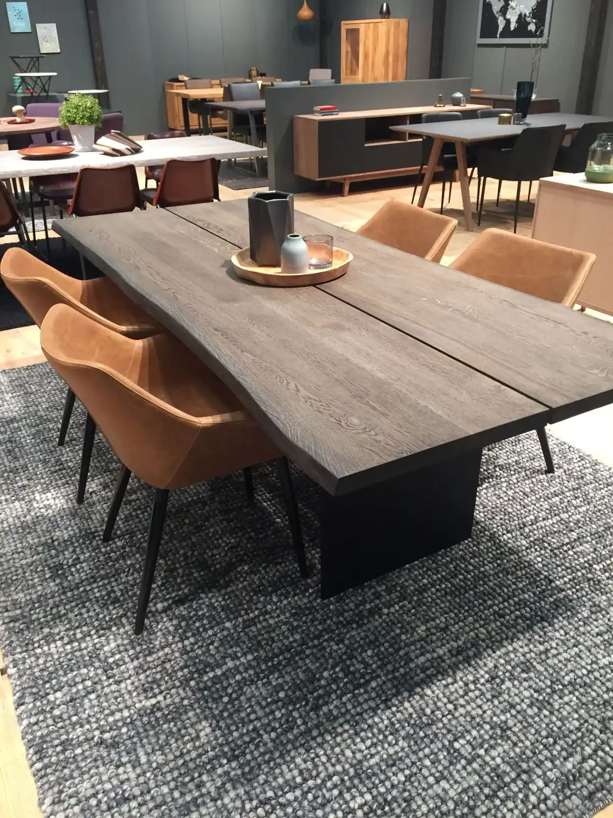 Modern cutting edge wooden table with brown leather chairs