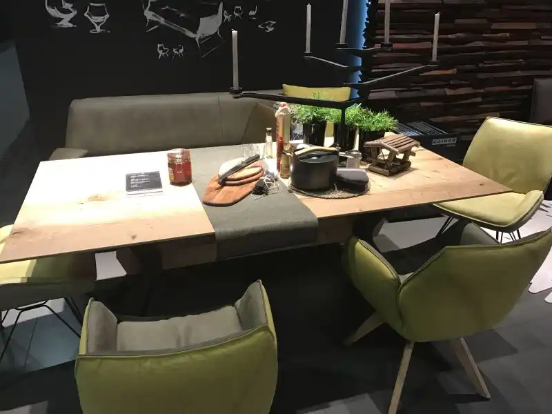 Modern dining room with bench and armchairs in leather