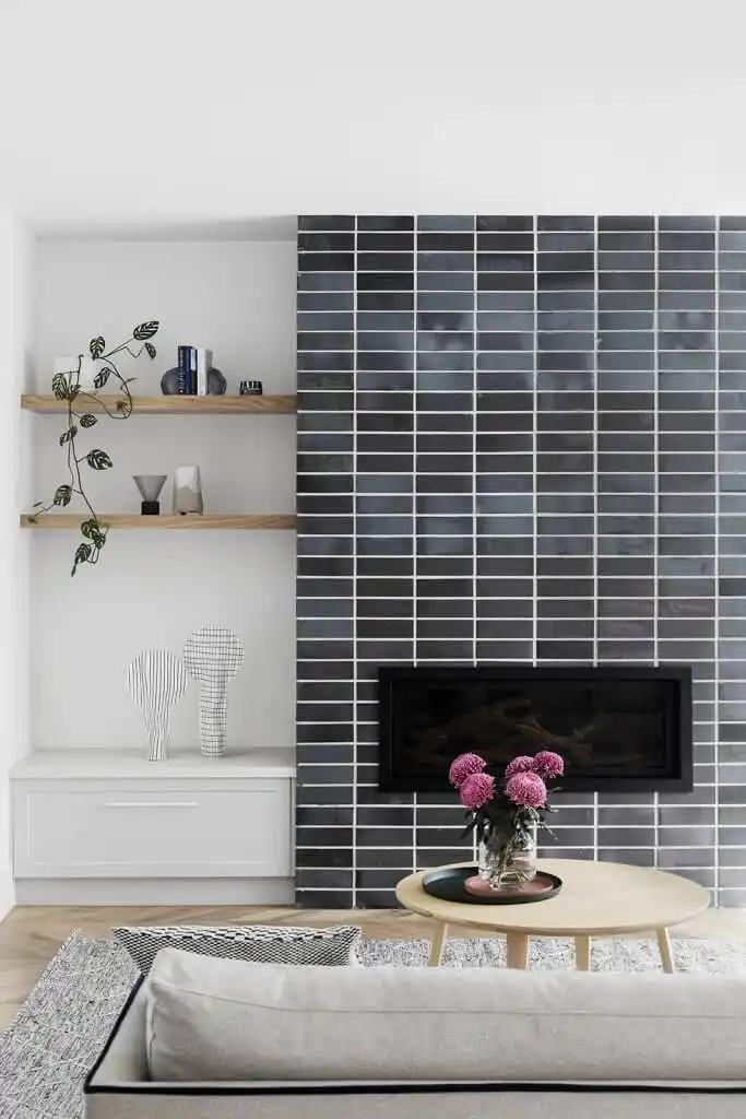 Modern room with fireplace covered in gray tiles