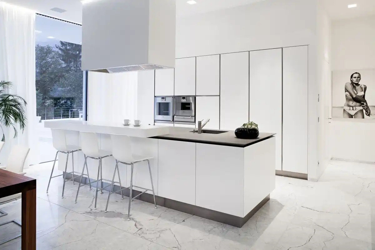 Modern white kitchen with marble floor and large kitchen island