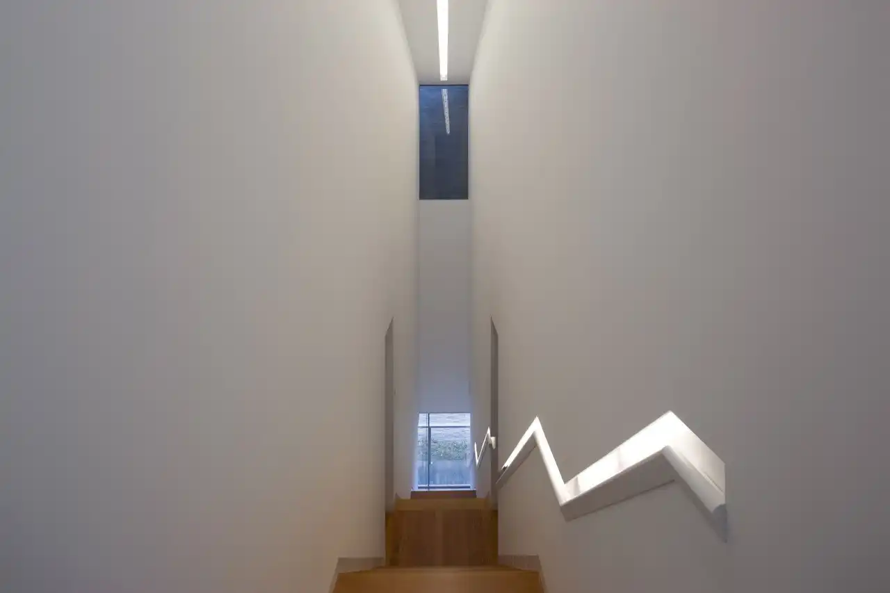 Narrow staircase with built in handrail