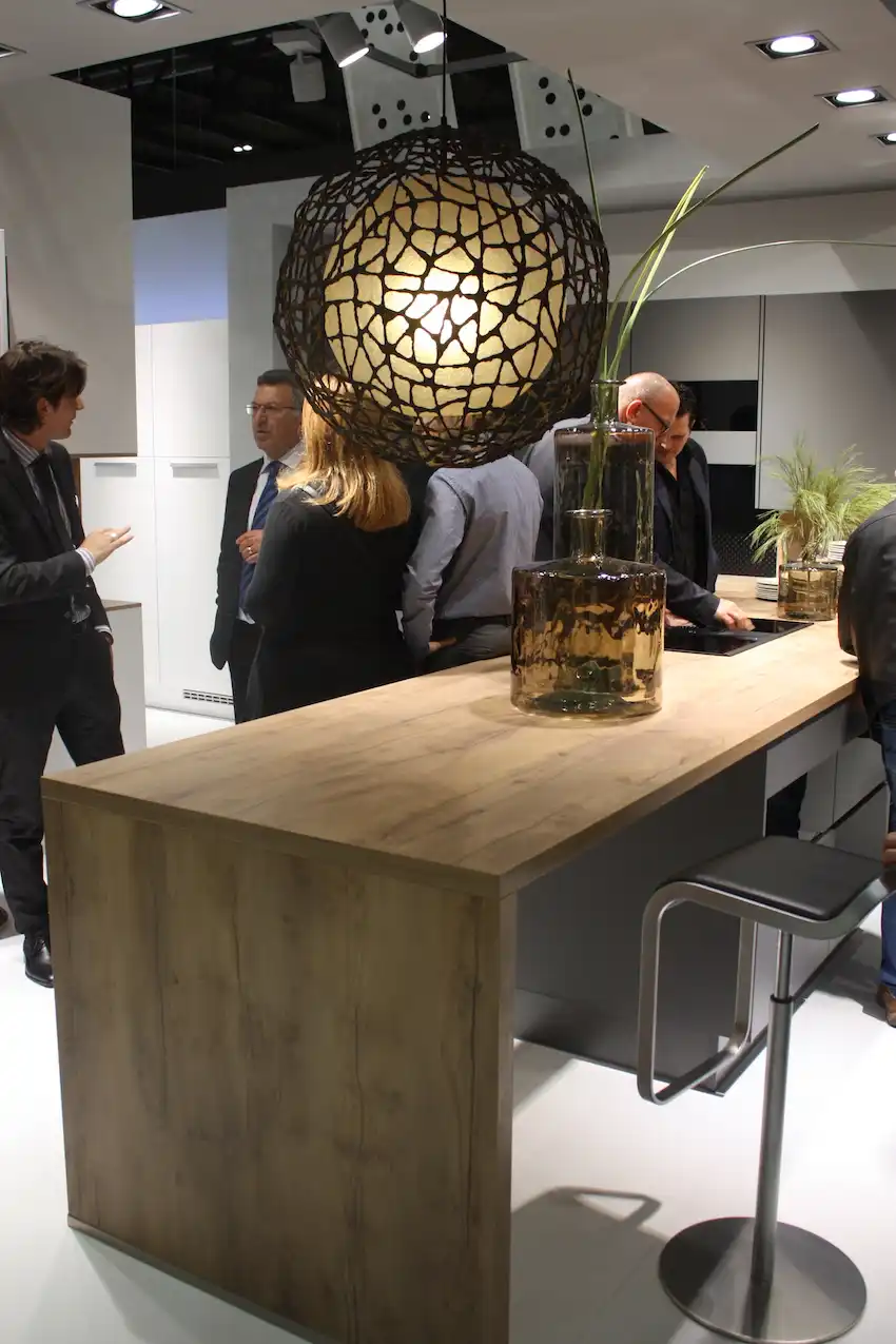 Nobilia displayed a kitchen design with natural wood elements, the perfect backdrop for this marvelous pendant lighting fixture. Large and dramatic, with a bit of mystery, it's very appealing.