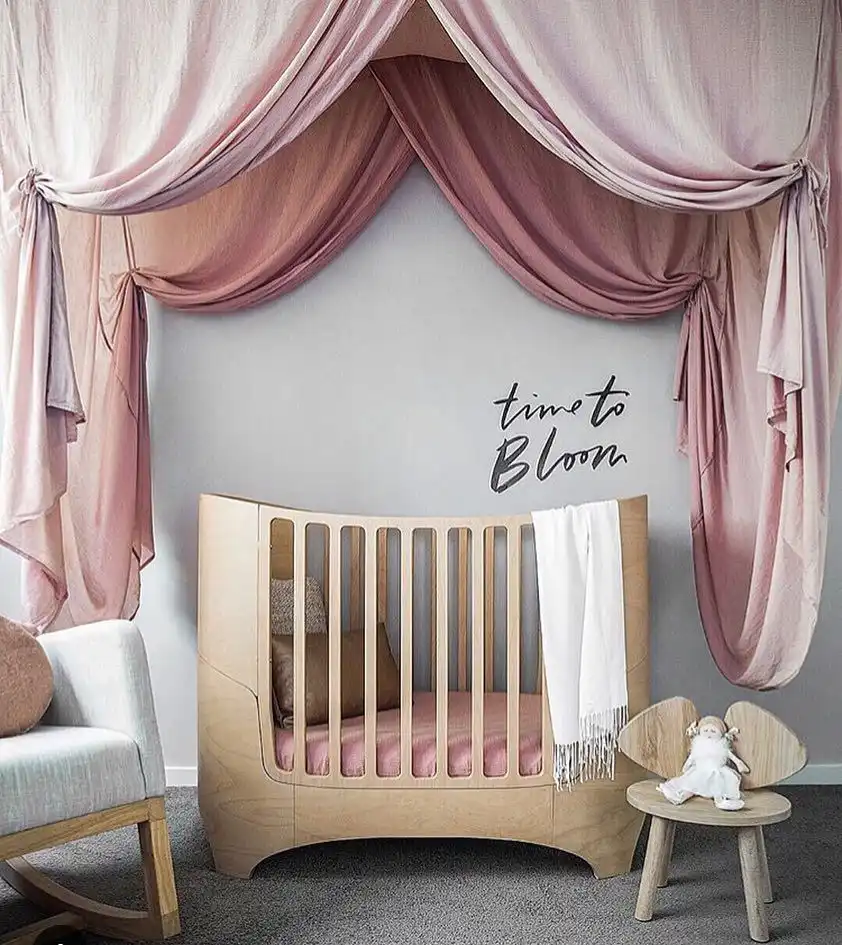 Nursery room crib with large drape