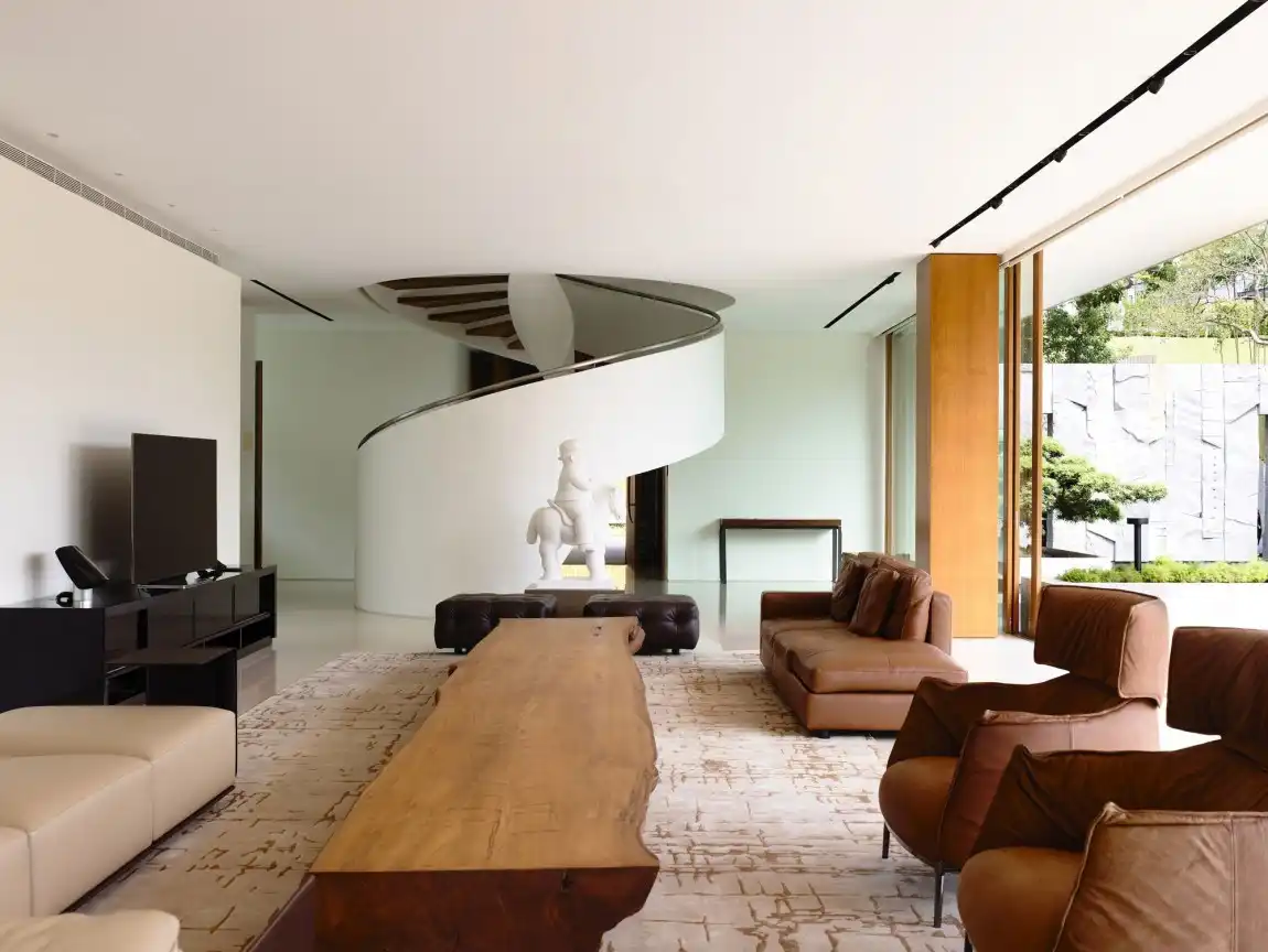 ONG&ONG Pte Ltd living room with spiral staircase and long live edge coffee table