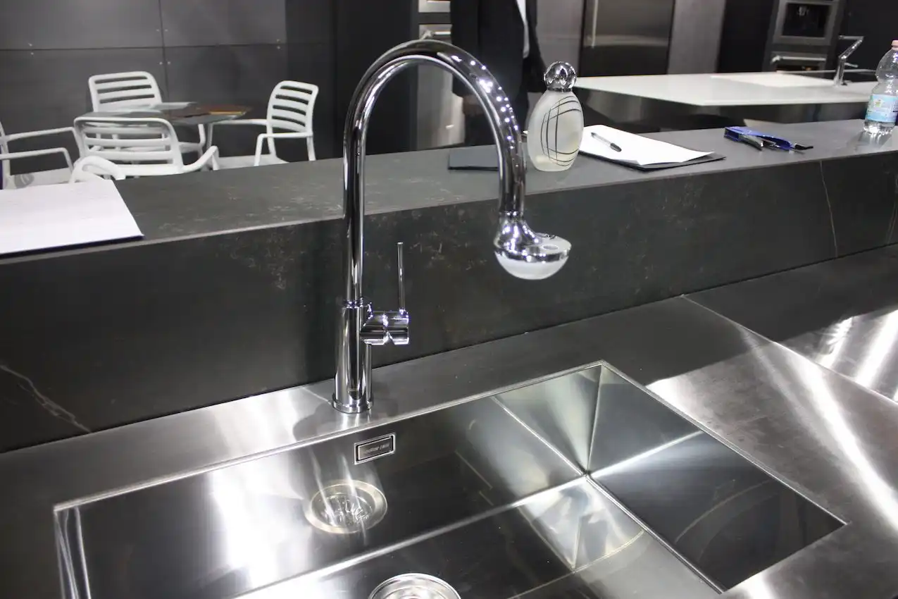 Officine Fanesi uses soapstone with stainless steel and modern fixtures in this kitchen.