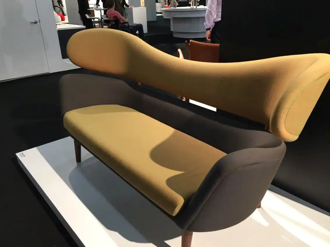 The two-part construction and sinuous lines of the Baker sofa make the large and substantial piece seem light.