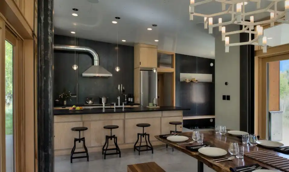 Open floor plan kitchen with black stools