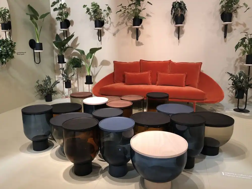 Orange sofa and lots of glass round tables